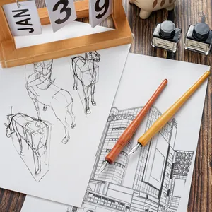 Detail of two vintage wooden dip pens with metal nibs on drawing sketches with ink