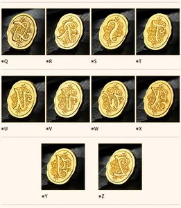 Details of vintage gold wax seal stamps featuring ornate alphabet letters from Q to Z