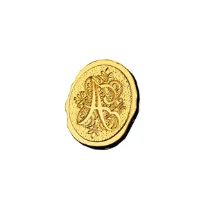 Vintage golden metal wax seal stamp head featuring an ornate floral letter A engraving
