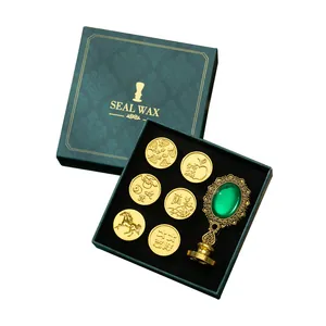 Juego de sellos de lacre vintage con seis cabezales dorados y mango decorativo verde
