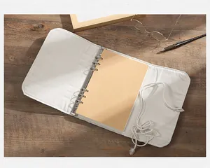 Detailed view showing the interior of a retro fabric binder notebook with blank kraft paper