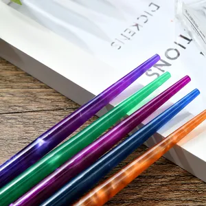 Macro shot of colorful translucent resin dip pen barrels in purple green and orange