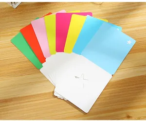 Close-up detail of colorful star cutout greeting cards neatly stacked on a wooden desk