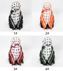 Selection of four polka dot satin square scarves in black, orange, red and green.