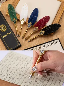 Detailed view of luxury gold-dusted feather quill pen set with calligraphy nibs