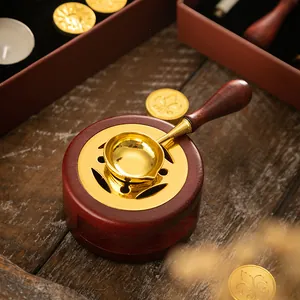 Retro wooden sealing wax furnace set with a golden spoon on a wooden background