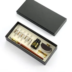 Elegant vintage wooden dip pen gift set with multiple nibs and ink bottle in a black box.
