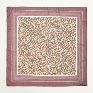 Detailed macro view of a chic leopard print chiffon square scarf with elegant border pattern