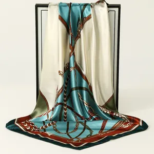 Elegant detail of a high-quality satin square scarf with a vintage chain print design.