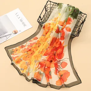 Detailed view of a lightweight Georgette scarf featuring vibrant orange floral prints