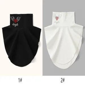 Detailed view of black and white women's fake collars with rhinestone heart designs