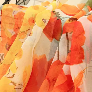 Close-up detail of lightweight Georgette silk scarf with vibrant orange floral print.