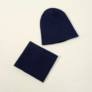 Detailed view showing the ribbed knit texture of navy blue beanie hat and neck scarf set