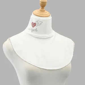 Detailed view of the red rhinestone heart and angel script on a white turtleneck dickey collar