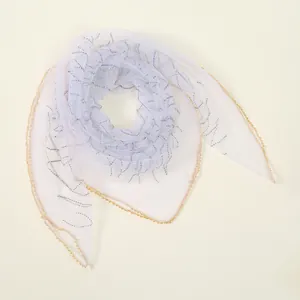 Close-up of lightweight lavender polyester square scarf with sparkling rhinestone patterns