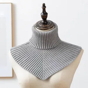 Detailed view of a grey ribbed knit turtleneck false collar neck warmer on a mannequin torso