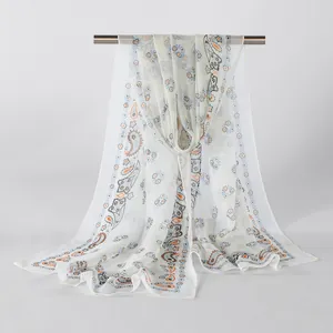 Elegant detailed view of white floral georgette scarf hanging on a sleek metal bar