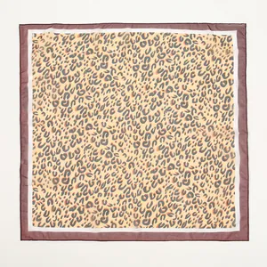 Flat lay view of a leopard print chiffon square scarf showing the full pattern design