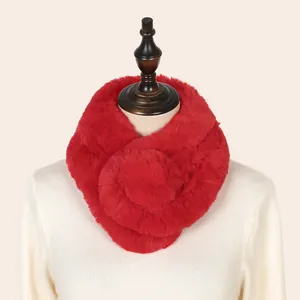 Close-up detail of a vibrant red faux rabbit fur neck warmer on a soft white sweater.