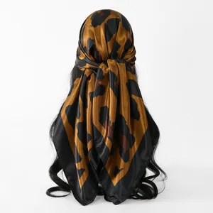 Close-up of leopard print satin square scarf tied on hair for a stylish summer look