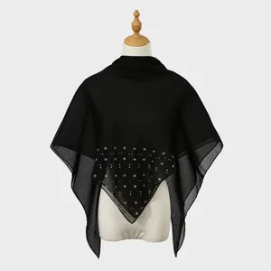 Detail of black sheer mesh shawl featuring elegant rhinestone floral patterns.