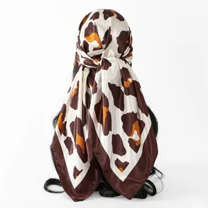 Stylish leopard print satin square scarf tied on hair, showing back view detail.