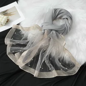 Elegant gray organza scarf detail with sparkling rhinestones and delicate pearls