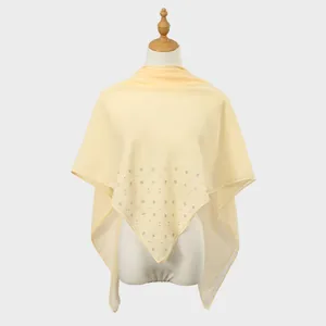 Detailed view of pale yellow sheer chiffon shawl with elegant rhinestone flower motifs