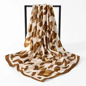 Elegant leopard print satin square scarf showing smooth texture and drapes on frame