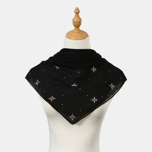Detailed view of black gauze square scarf featuring sparkling rhinestone floral patterns