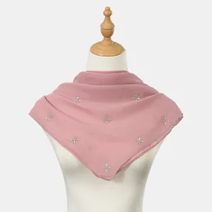 Detailed view of pink breathable yarn square scarf with sparkling rhinestone floral patterns.