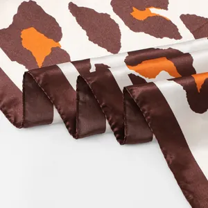 Detailed view of silky satin leopard print square scarf showing pattern and texture