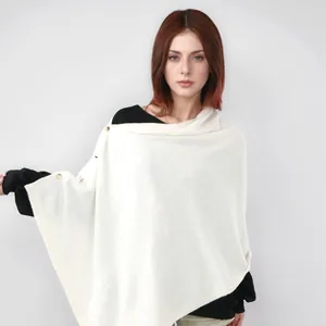 Elegant white knitted poncho shawl with gold buttons for women in autumn and winter