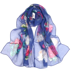 Macro view of blue floral print chiffon scarf with lightweight translucent texture