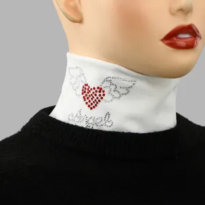 Close-up view of the rhinestone heart and angel detail on white velvet fake collar