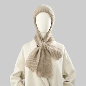 Close-up of beige fuzzy knitted balaclava hood and scarf for winter warmth