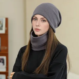 Female model wearing grey ribbed knit beanie hat and matching thick neck warmer for winter