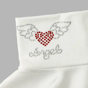 Macro detail of sparkly rhinestone heart and wings design on white thermal faux collar