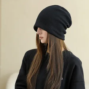 Stylish black knitted slouchy beanie for women, perfect for warm autumn and winter wear.