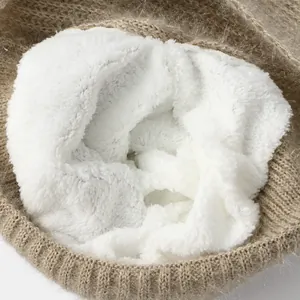 Macro view showing the soft and thick white plush lining of the khaki winter hat