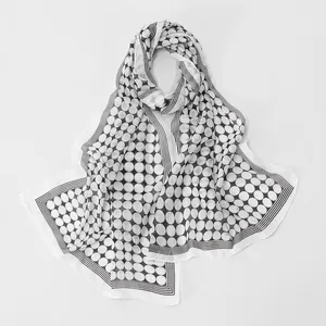 Close-up detail of a lightweight black and white polka dot chiffon scarf with stripes