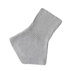 Macro detail shot showing the ribbed texture of a grey knitted winter neck gaiter warmer