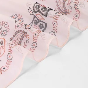 Close-up detail of the floral paisley pattern on pink georgette chiffon scarf fabric