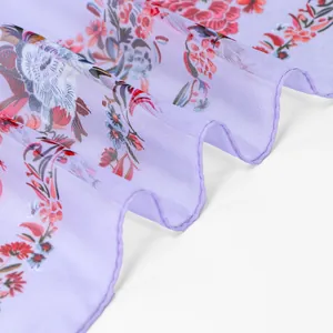 Detailed macro view showing lavender floral georgette fabric with a delicate ruffled edge finish