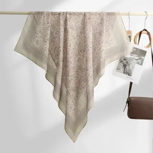 Elegant vintage floral print bali yarn square scarf shown in a detailed hanging presentation