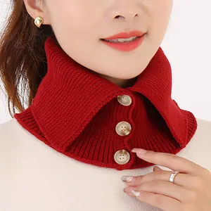 Primer plano de un cuello falso de punto rojo con diseño de tres botones en modelo
