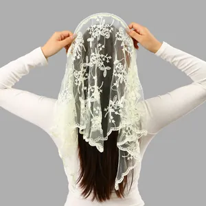 Close-up of elegant floral embroidered white lace bridal veil scarf worn by a model.