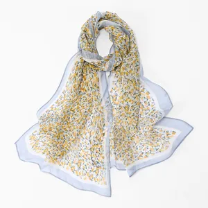 Close-up of elegant floral print georgette scarf with light blue border detail