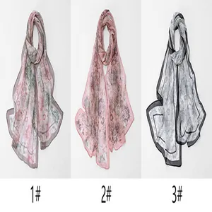 Detailed view of three floral georgette scarves in various colors for sun protection