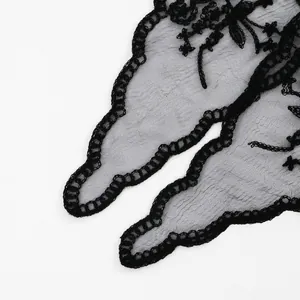 Close-up detail of black floral lace embroidery on a delicate sheer bridal mesh veil.